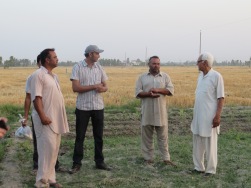 Monu (in the cap) and Uncle Ji (on the right) talking with the farm hands